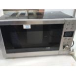 A MICROWAVE (SLIGHT DAMAGE TO CASING SEE PHOTO)IN WORKING ORDER