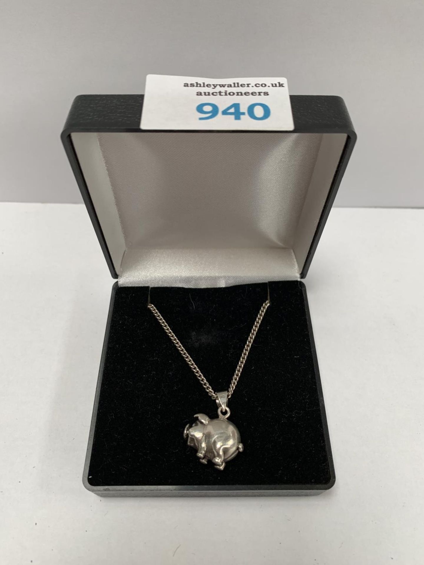 A BOXED SILVER NECKLACE WITH PIG PENDANT