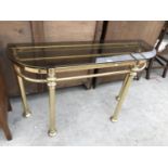 A BRASS HALL TABLE WITH SMOKED GLASS TOP