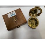 A WOODEN BOX CONTAINING VINTAGE BRASS COMPASS