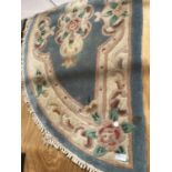 AN BLUE PATTERNED SEMICIRCULAR RUG APPROX 70CM X 140CM