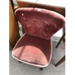 A PINK UPHOLSTERED BEDROOM CHAIR