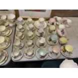 A LARGE COLLECTION OF CERAMIC CUPS AND SACUERS
