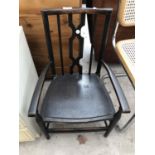 AN EBONISED CARVER DINING CHAIR