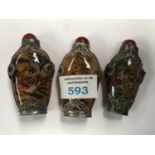 THREE DECORATIVE ORIENTAL SNUFF BOTTLES WITH WHITE METAL MOUNTS