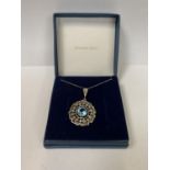 A SILVER NECKLACE WITH BLUE GEM STONE PENDANT