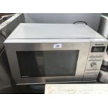 A STAINLESS STEEL PANASONIC MICROWAVE IN WORKING ORDER