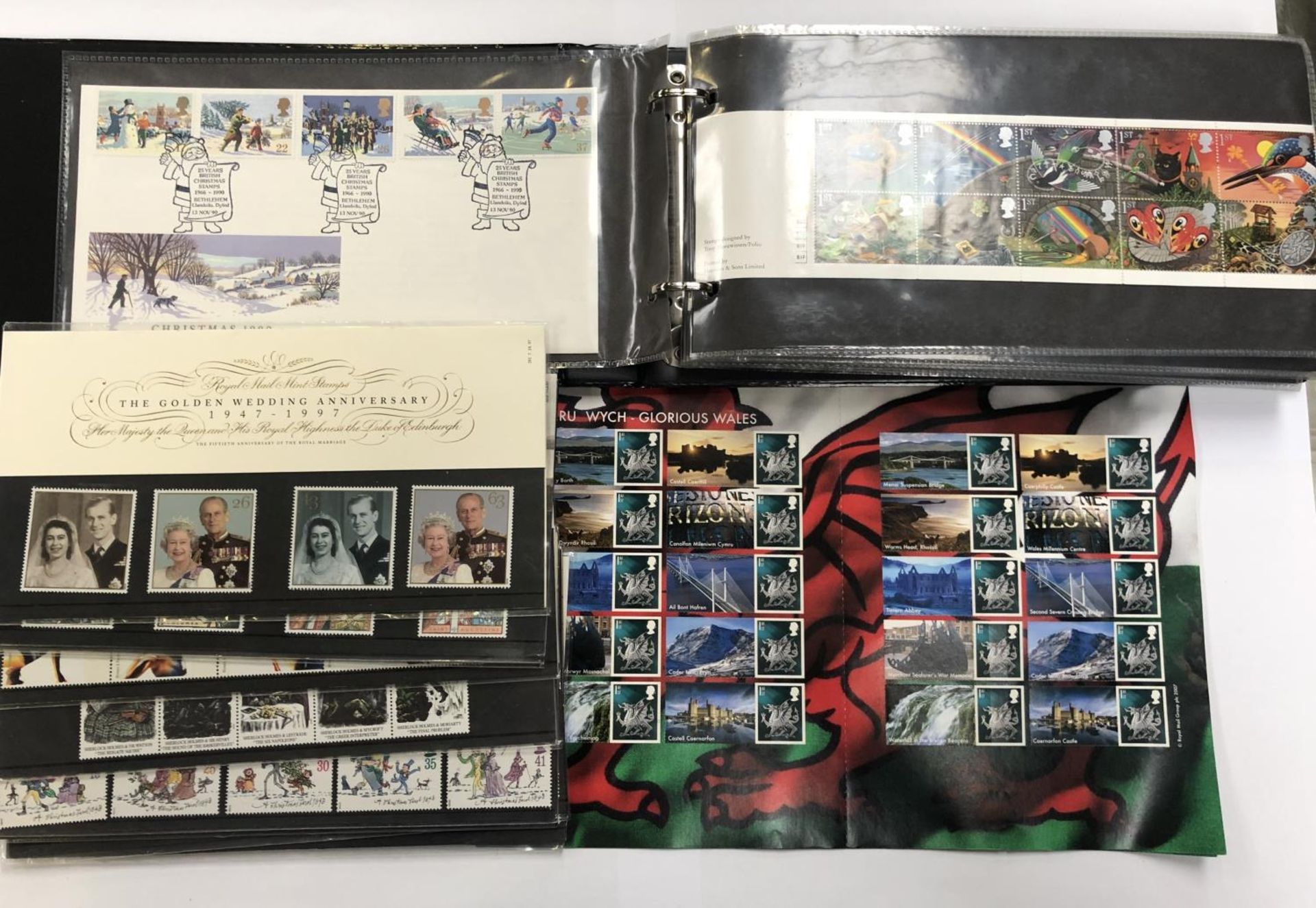 A FIRST DAY COVER ALBUM, COMMEMORATIVE STAMP SETS ETC