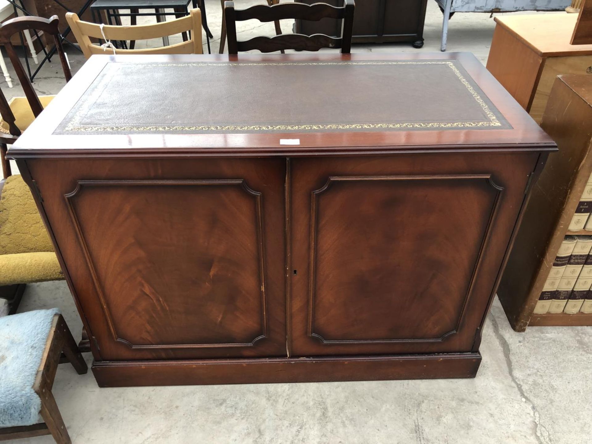 A LEATHER TOP MAHOGANY CABINET