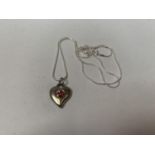 A SILVER NECKLACE WITH HEART PENDANT