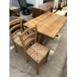 A MODERN PINE DINING TABLE AND TWO RUSH SEATED CHAIRS