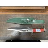 A HAND CRAFTED KNIFE AND GREEN LEATHER SLEEVE