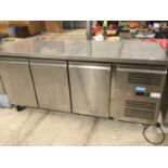 A LARGE THREE DOOR STAINLESS STEEL CHILLER UNIT WITH STAINLESS STEEL TOP IN WORKING ORDER