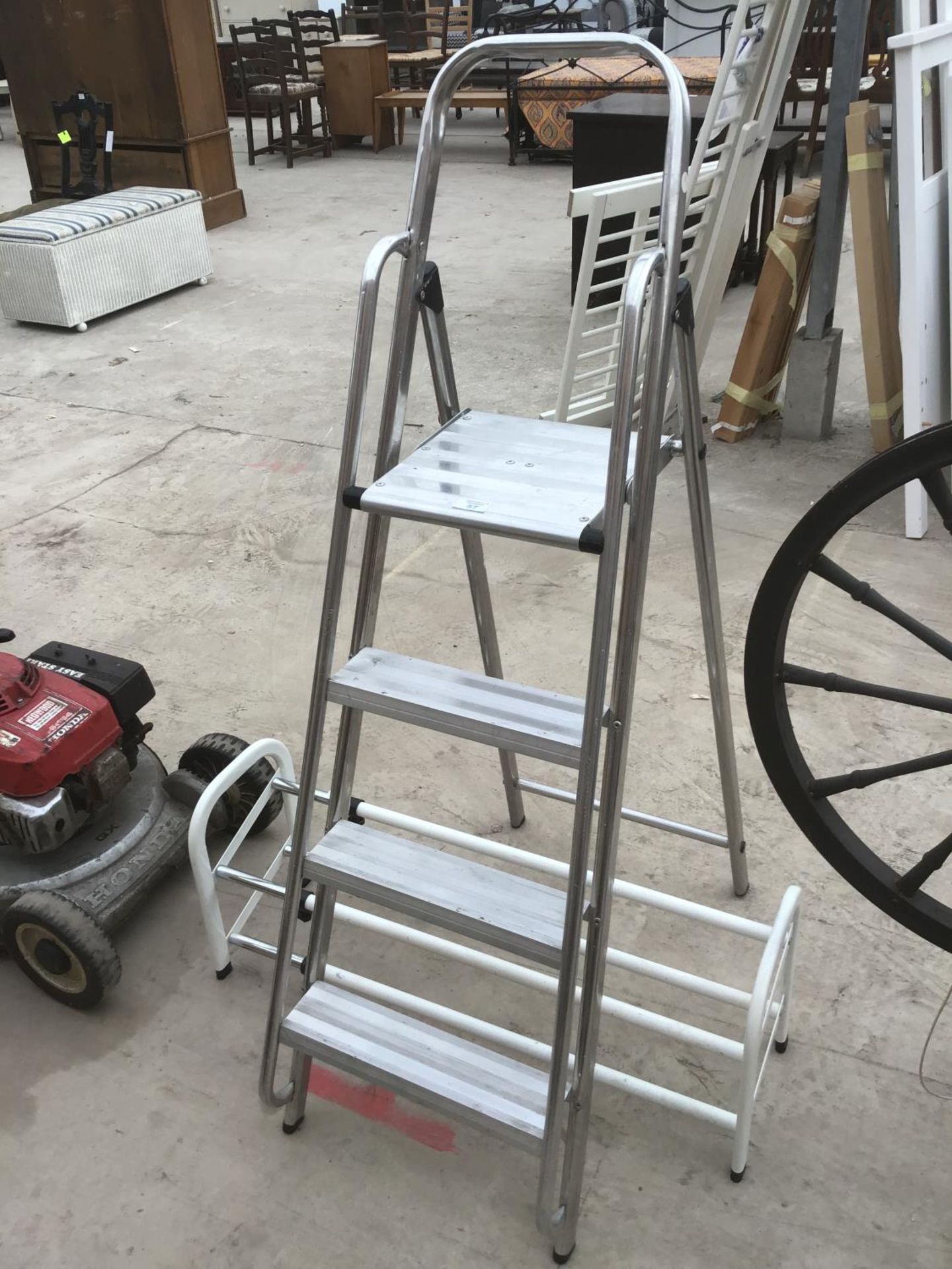 A FOUR RUNG ALUMINIUM STEP LADDER AND A SHOE RACK