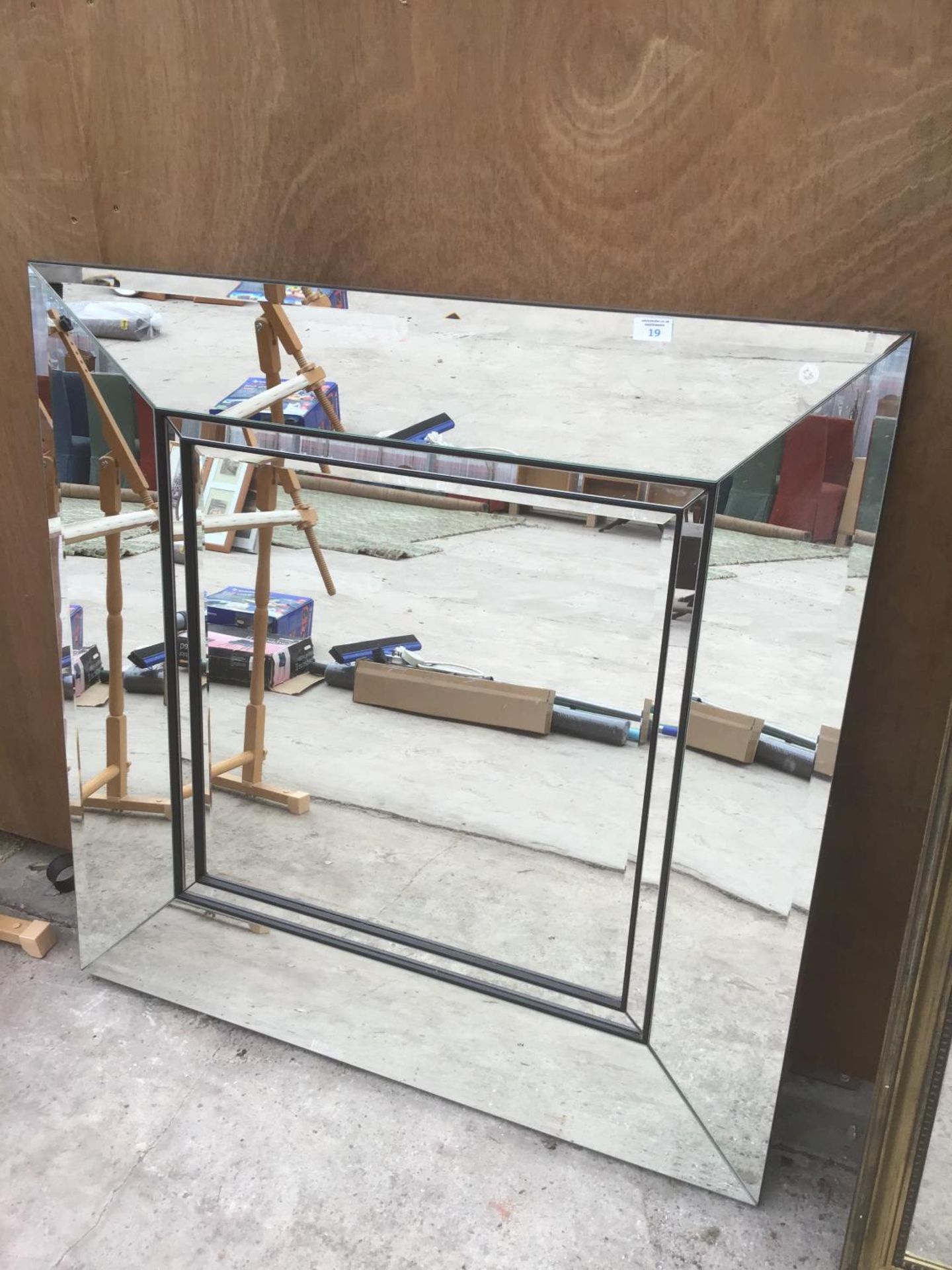 A LARGE SQUARE MIRROR WITH MIRRORED FRAME (SLIGHT DISCOLOURATION TO RH CORNER - SEE PICTURE)