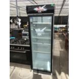 A SINGLE GLASS DOOR TALL DISPLAY FRIDGE WITH SMIRNOFF ICE ADVERTISING ON SIDES IN WORKING ORDER