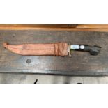 A HAND CARVED PHILIPPINE 1968 NEGRITO BOLO KNIFE WITH LEATHER SLEEVE