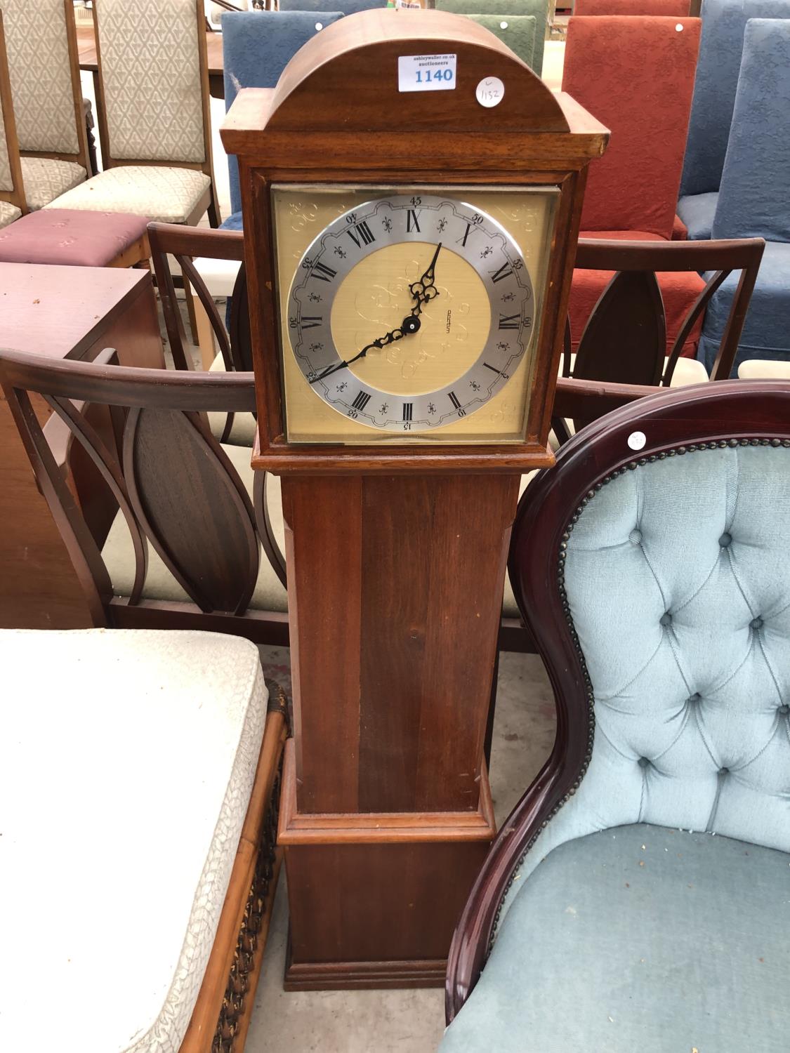 A MINIATURE WOODEN CASED ACTIM CLOCK