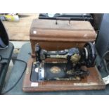 A JONES VINTAGE SEWING MACHINE WITH CARRY BOX AND KEY