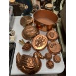 A LARGE COLLECTION OF COPPER JELLY MOULDS AND A COPPER-BRASS COOKING POT