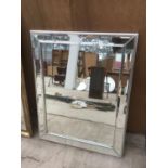 A LARGE MIRROR WITH MIRRORED FRAME