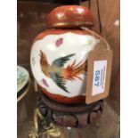 A CHINESE PHOENIX GINGER JAR ON CARVED WOODEN BASE