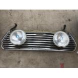 A MINI COOPER GRILL WITH TWO HELLA HALOGEN HEADLIGHTS
