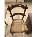 A MAHOGANY DINING CHAIR WITH RATTAN SEAT