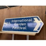 A LARGE 'INTERNATIONAL GARDEN FESTIVAL' SIGN