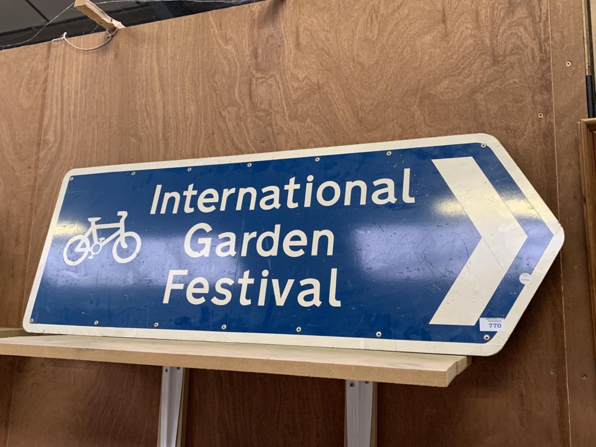 A LARGE 'INTERNATIONAL GARDEN FESTIVAL' SIGN