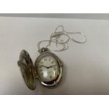 A WHITE METAL CHAIN AND OVAL POCKET WATCH
