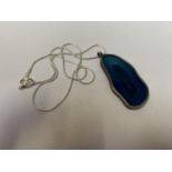 A SILVER NECKLACE WITH LARGE BLUE PENDANT