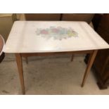 A RETRO KITCHEN TABLE WITH FLORAL DESIGN TOP