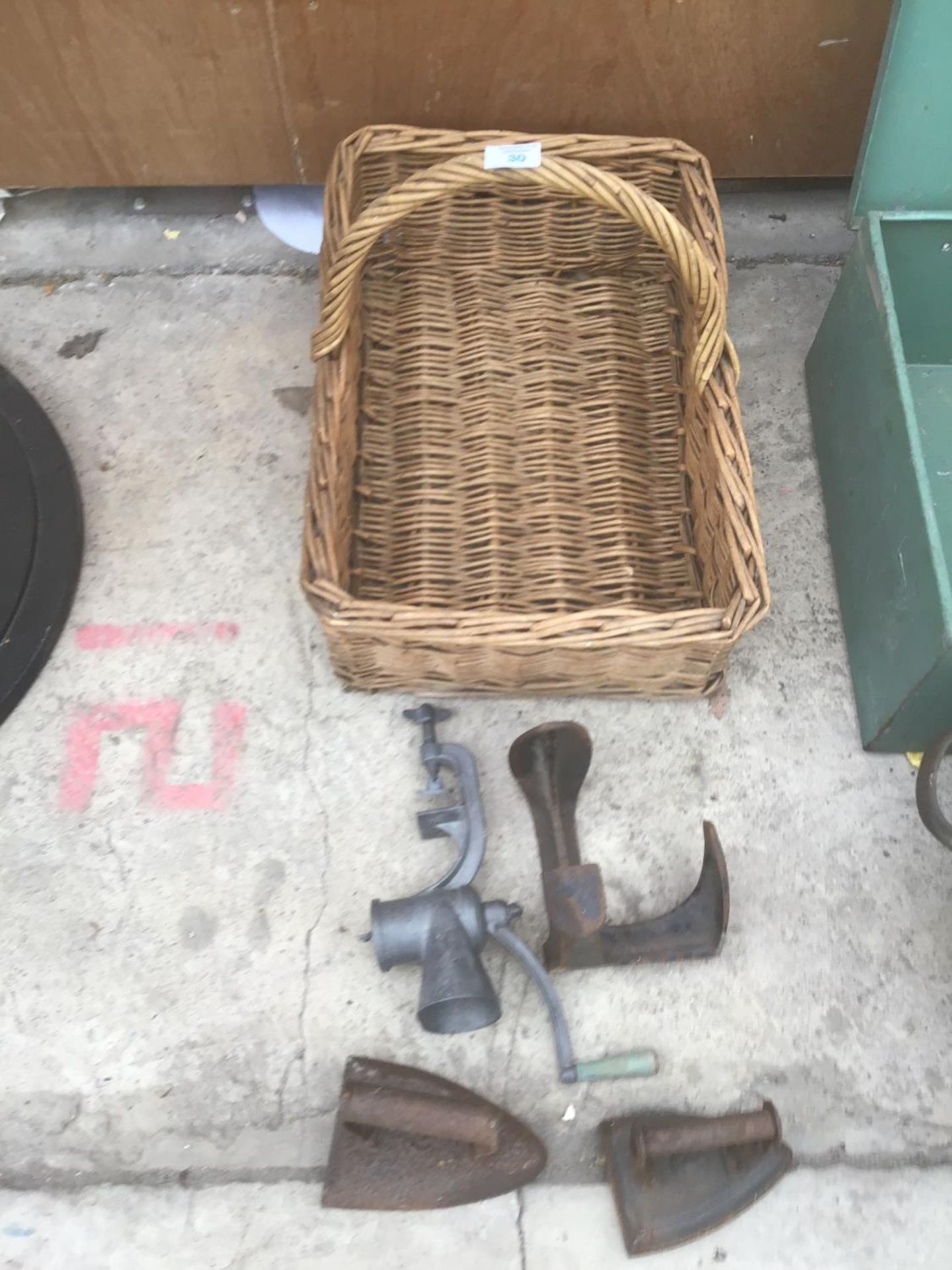 A VINTAGE WICKER PICNIC BASKET,TWO IRONS,A SHOE LAST AND A MINCER