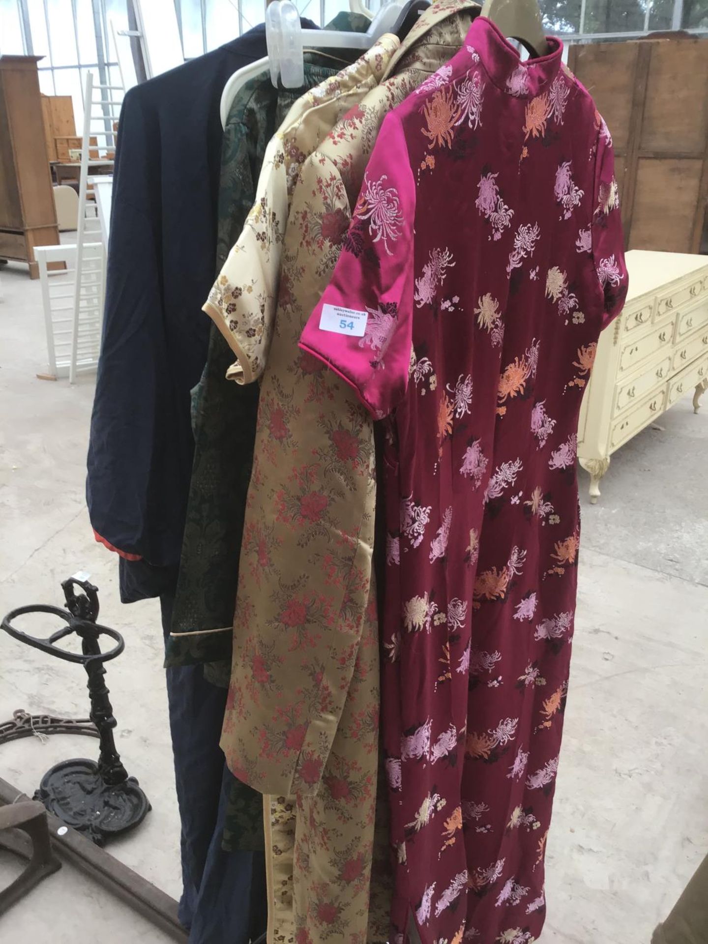 A COLLECTION OF CHINESE STYLE CLOTHING TO INCLUDE THREE DRESSES, A COAT, PYJAMAS AND A 100% SILK
