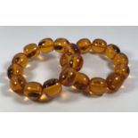 TWO AMBER TYPE ORIENTAL INSECT BRACELETS