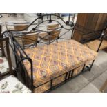 A WROUGHT IRON SOFA BED WITH FLORAL DESIGN