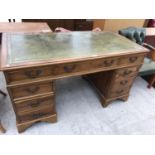 A GREEN LEATHER TOPPED PEDESTAL KNEE HOLE DESK
