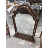 A CARVED MAHOGANY DRESSING TABLE MIRROR