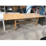 AN EXTENDING PINE DINING TABLE