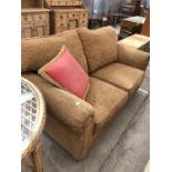 A MODERN BEIGE UPHOLSTERED TWO SEATER SOFA