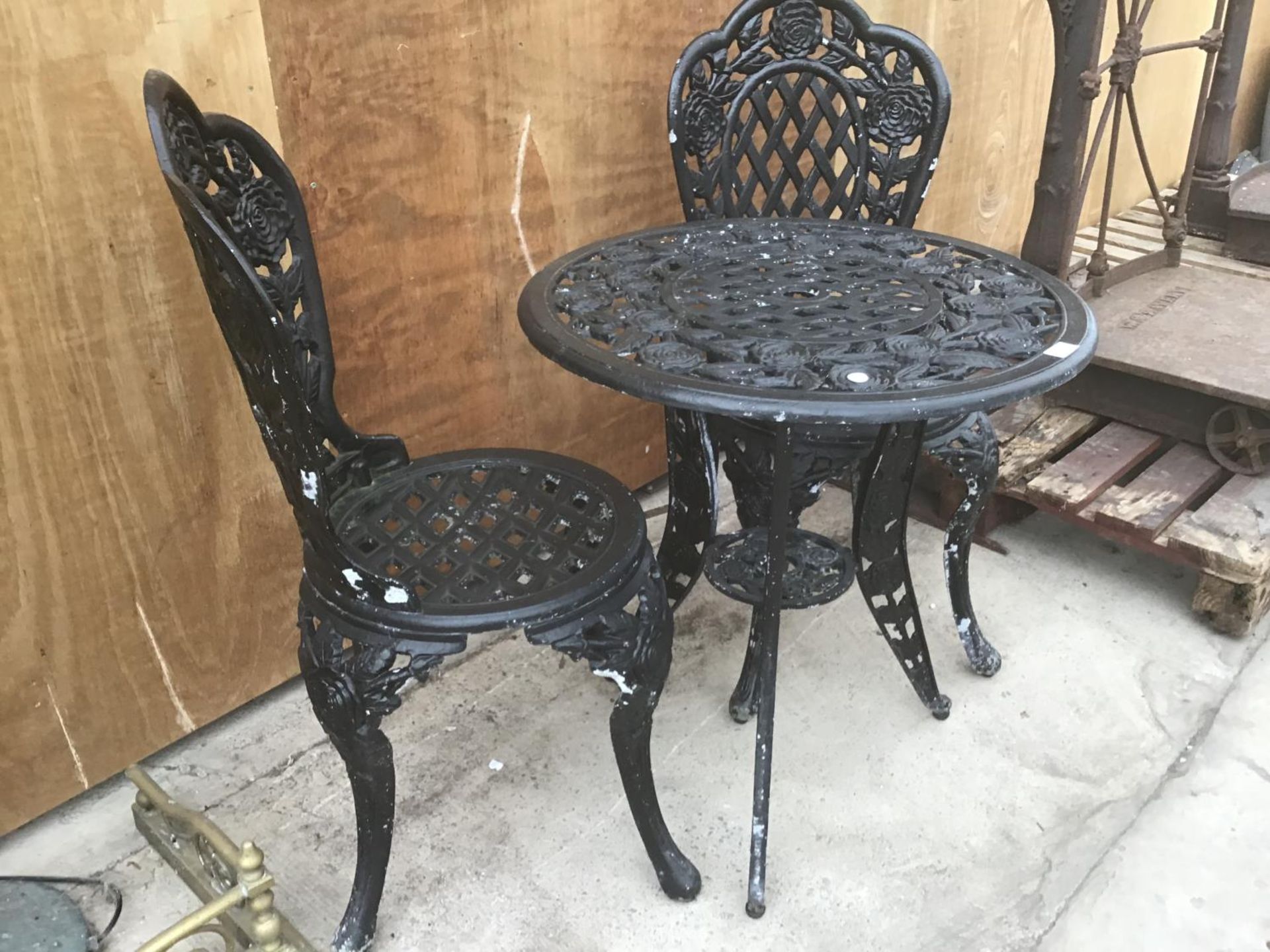 A HEAVY CAST IRON ROSE DESIGN TABLE WITH TWO MATCHING CHAIRS - Image 4 of 4