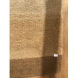 A BROWN AND BEIGE RUG APPROX 170CM X 117CM