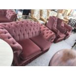 A BURGUNDY FIVE PIECE BUTTON BACK SUITE - A THREE SEATER SOFA, A TWO SEATER SOFA, TWO ARMCHAIRS