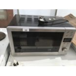 A MICROWAVE (SLIGHT DAMAGE TO CASING SEE PHOTO)IN WORKING ORDER