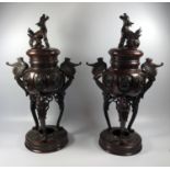 A PAIR OF IMPRESSIVE JAPANESE MEIJI PERIOD BRONZE LIDDED VASES WITH FOO DOG DESIGN TOPS, UNMARKED TO