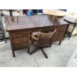 AN OAK DESK WITH SEVEN DRAWERS AND A 1950s OAK SWIVEL OFFICE CHAIR