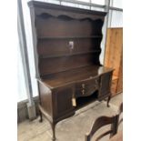 A MAHOGANY DRESSER WITH UPPER PLATE RACK AND LOWER DOORS AND DRAWERS ON CABRIOLE SUPPORTS