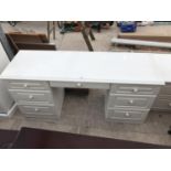 A MODERN WHITE DRESSING TABLE WITH SIX DRAWERS