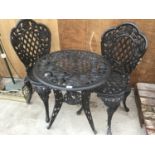 A HEAVY CAST IRON ROSE DESIGN TABLE WITH TWO MATCHING CHAIRS